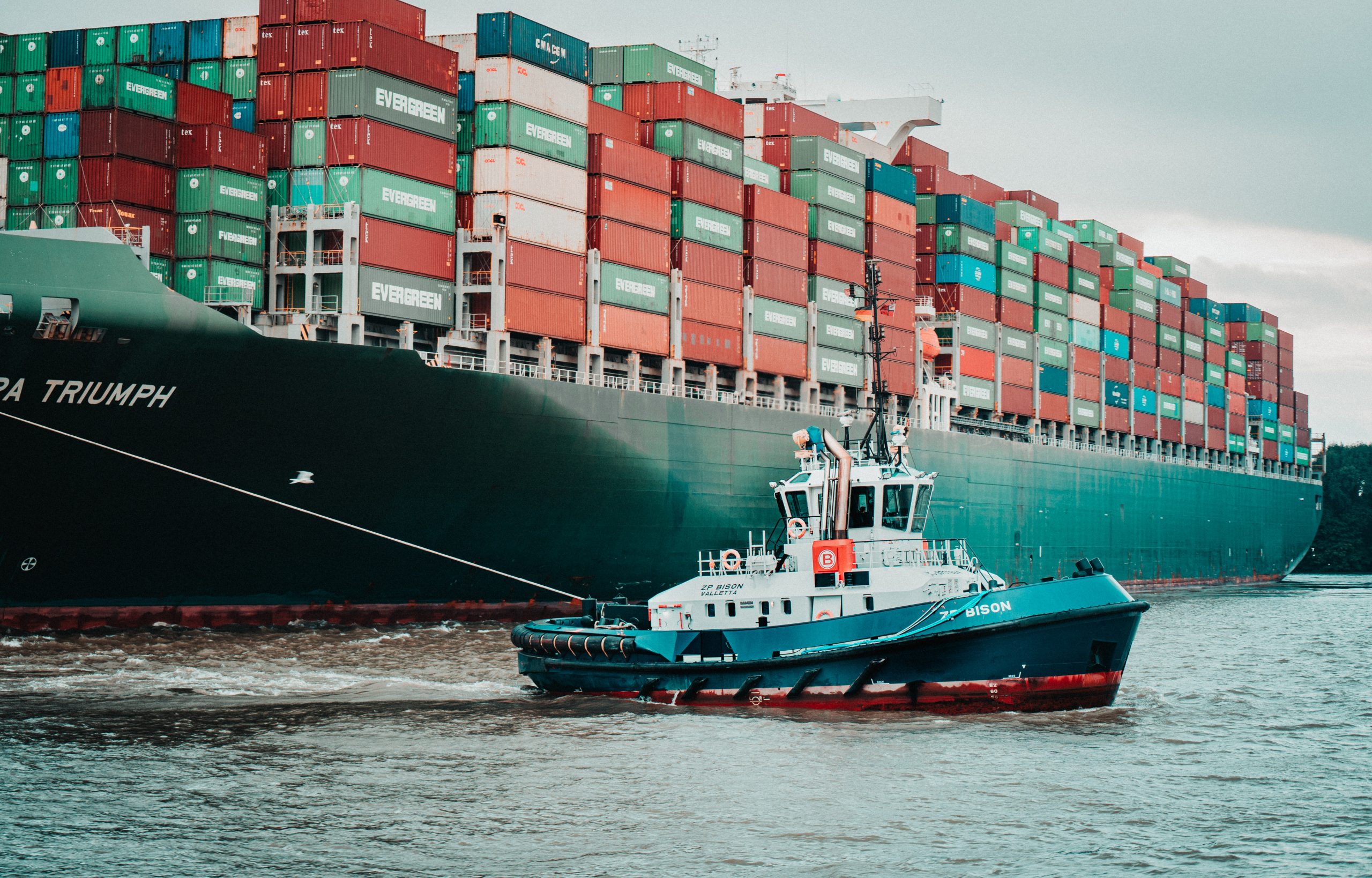 a boat linked to a cargo ship for logistics