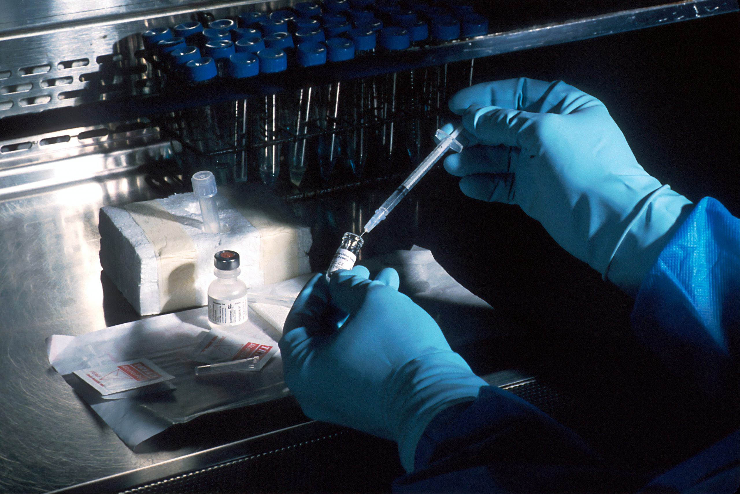 Scientist handling a vial and injection